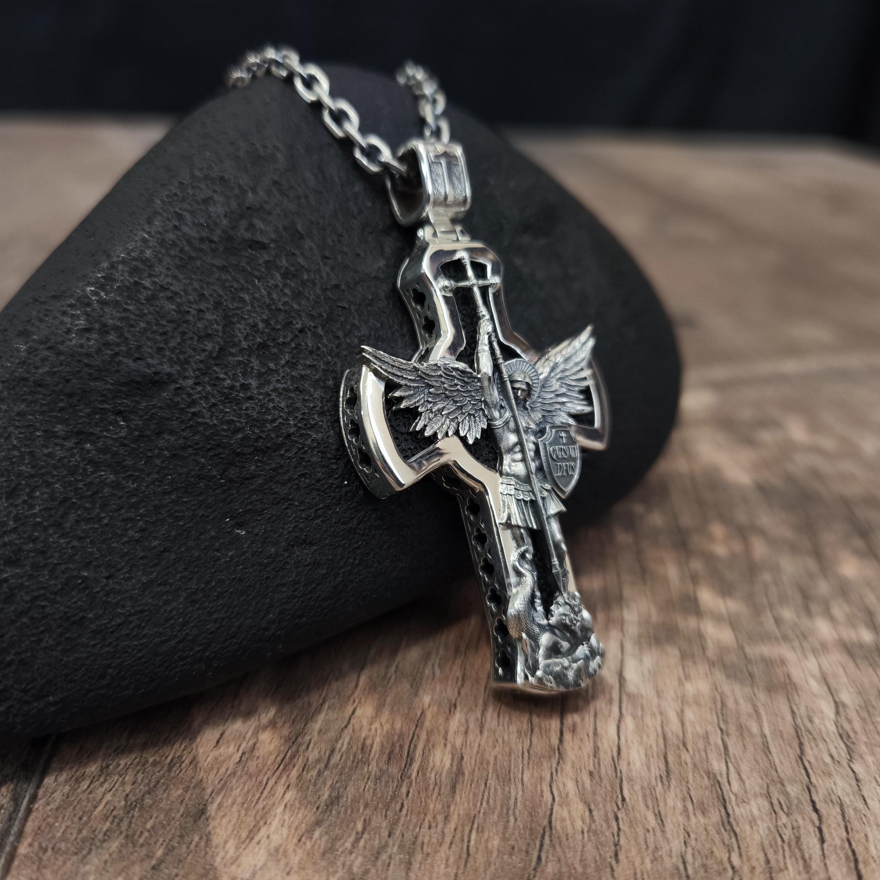 A sterling silver pendant in the shape of Archangel Michael's shield—a religious necklace made of ebony.