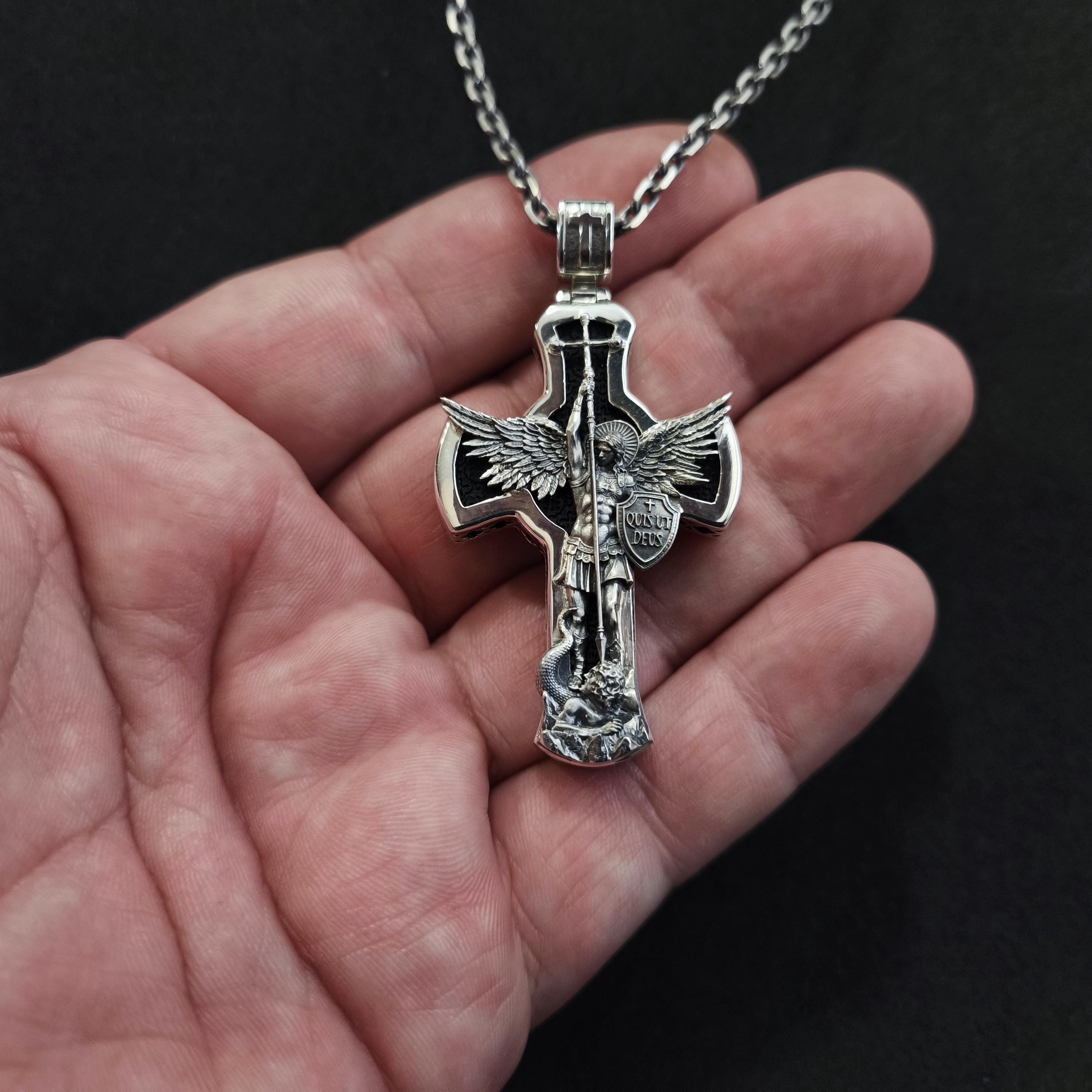 A sterling silver pendant in the shape of Archangel Michael's shield—a religious necklace made of ebony.