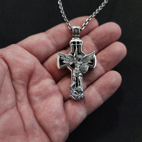 A sterling silver pendant in the shape of Archangel Michael's shield—a religious necklace made of ebony.