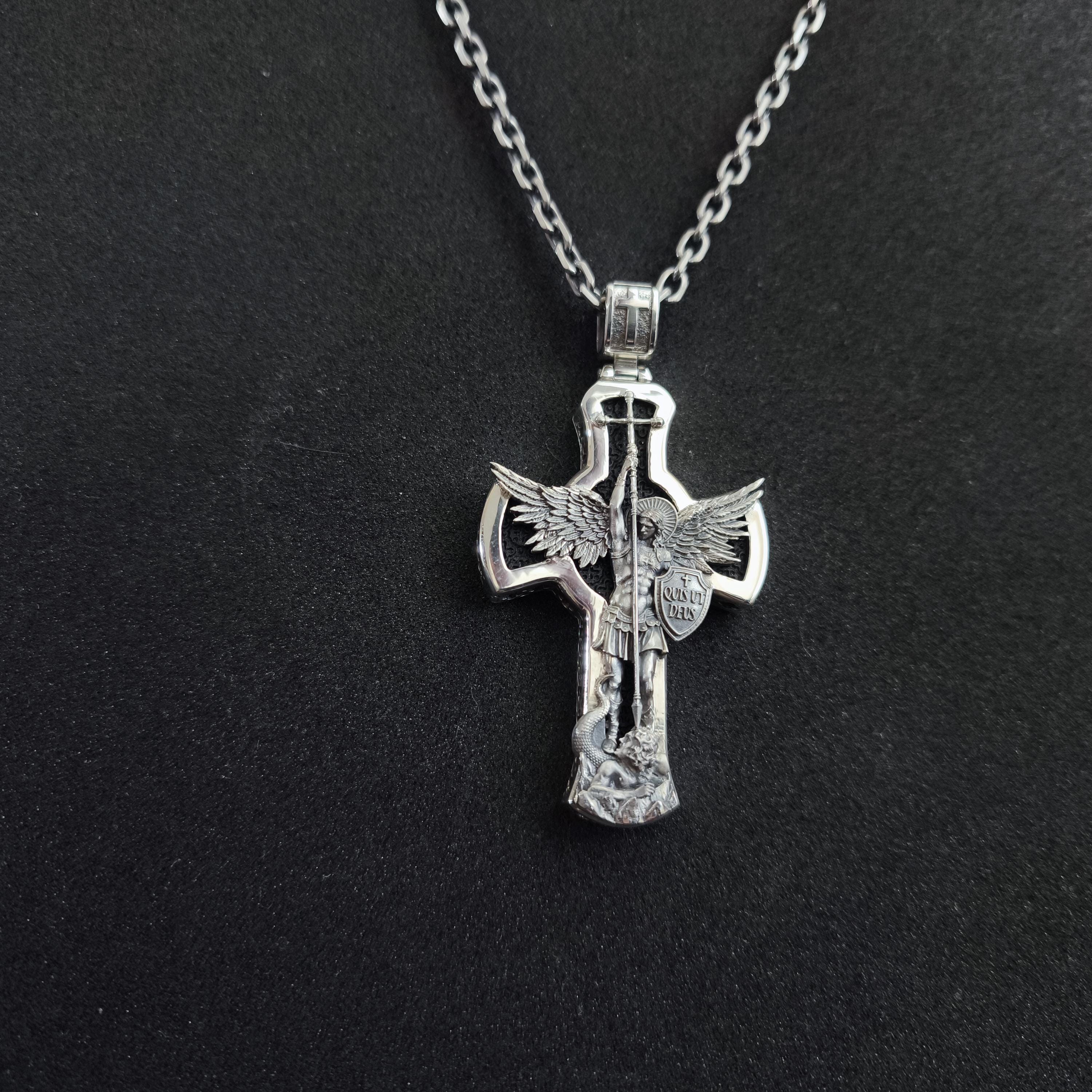 A sterling silver pendant in the shape of Archangel Michael's shield—a religious necklace made of ebony.