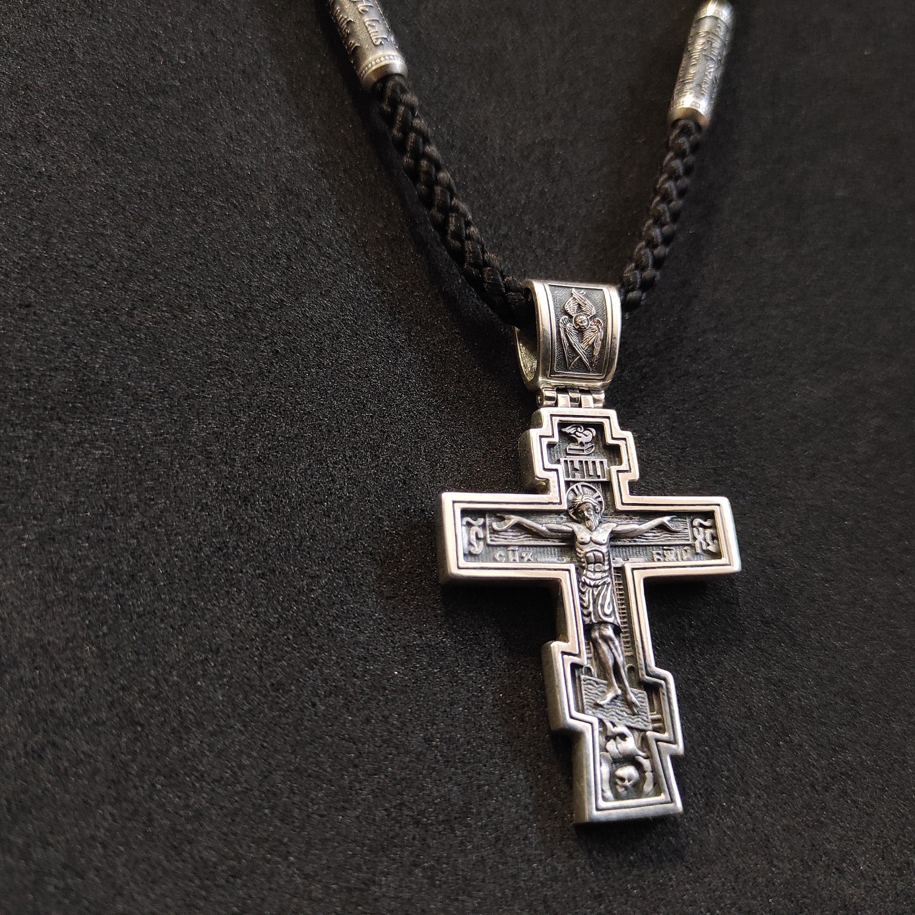 A sterling silver pendant in the shape of an Orthodox crucifix: a religious pendant.