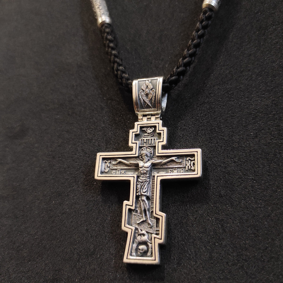 A sterling silver pendant in the shape of an Orthodox crucifix: a religious pendant.