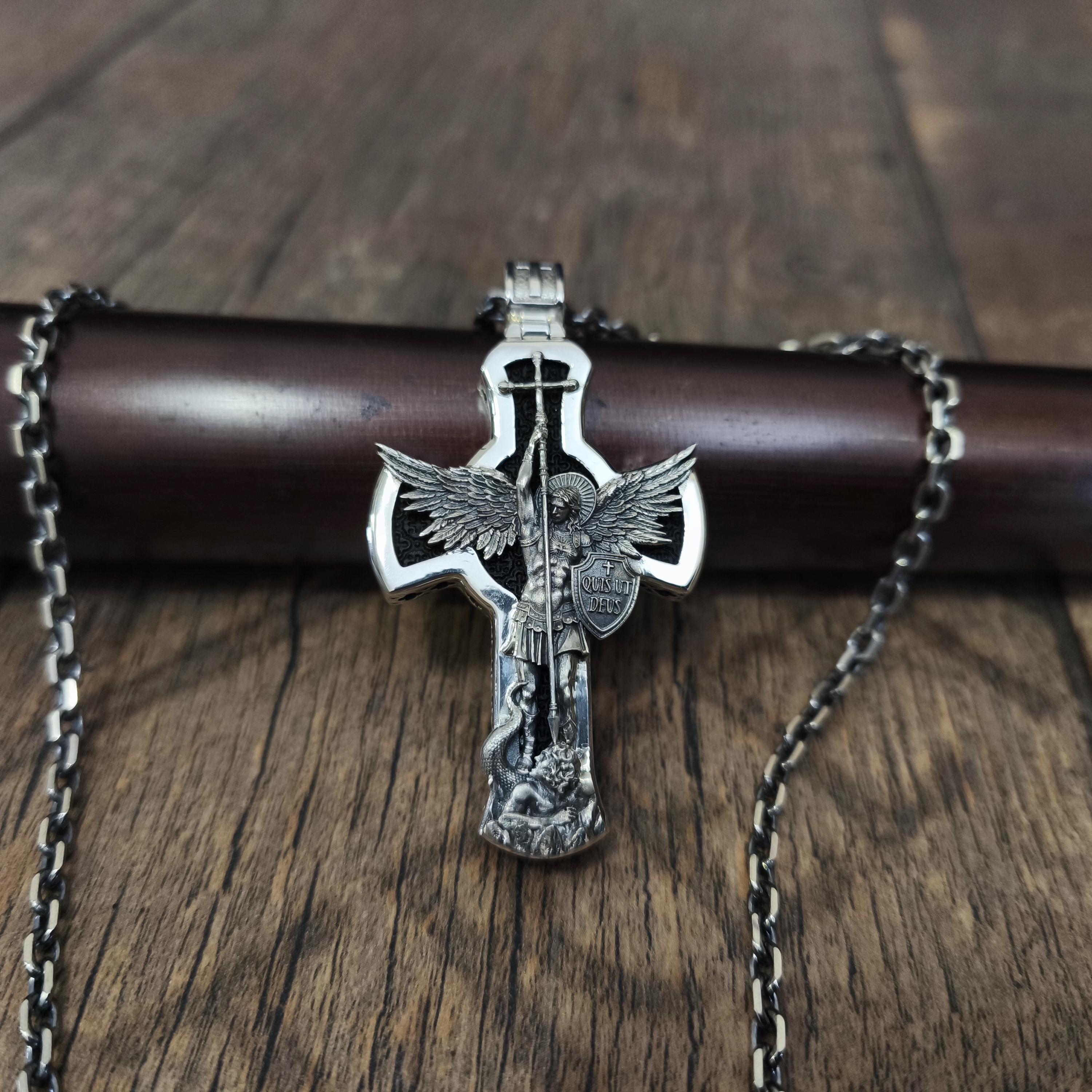 A sterling silver pendant in the shape of Archangel Michael's shield—a religious necklace made of ebony.
