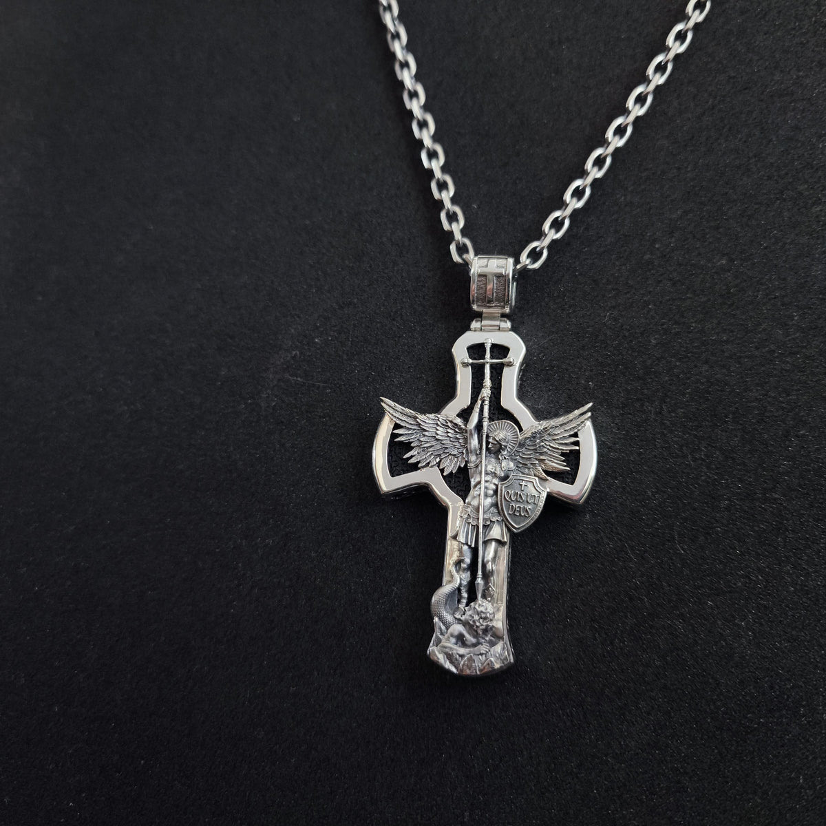 A sterling silver pendant in the shape of Archangel Michael's shield—a religious necklace made of ebony.