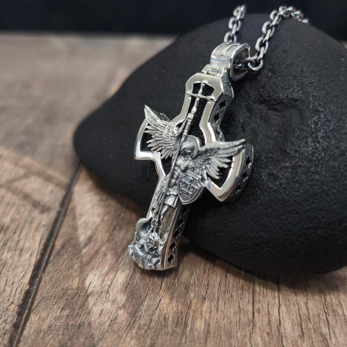 A sterling silver pendant in the shape of Archangel Michael's shield—a religious necklace made of ebony.