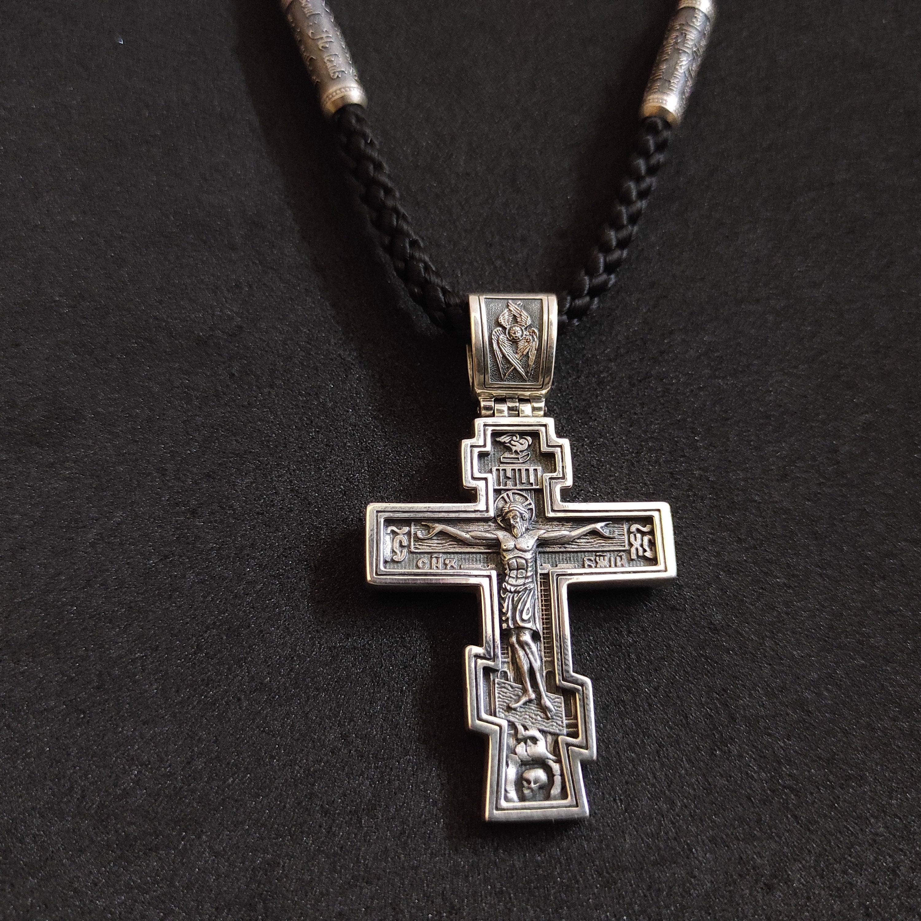 A sterling silver pendant in the shape of an Orthodox crucifix: a religious pendant.