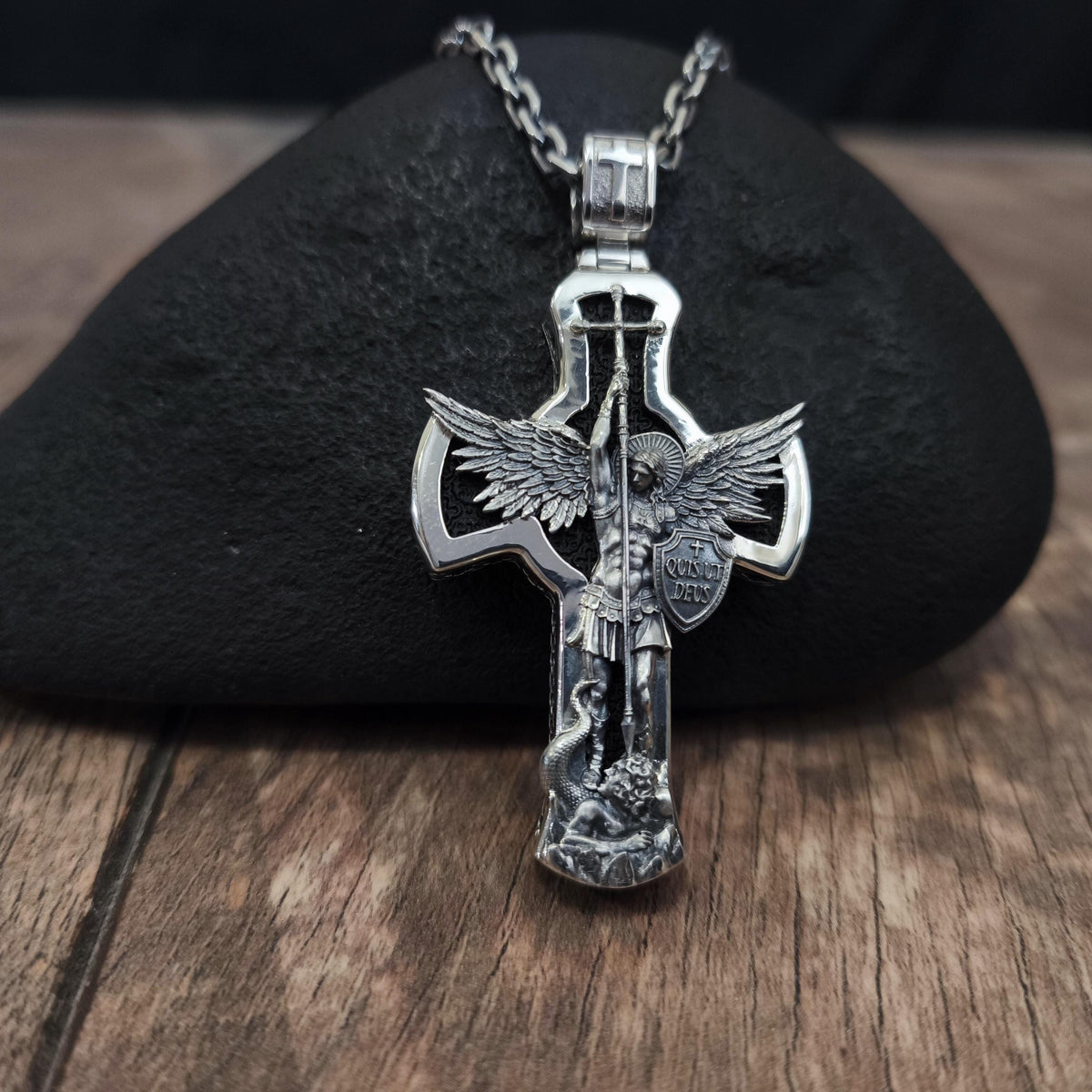 A sterling silver pendant in the shape of Archangel Michael's shield—a religious necklace made of ebony.