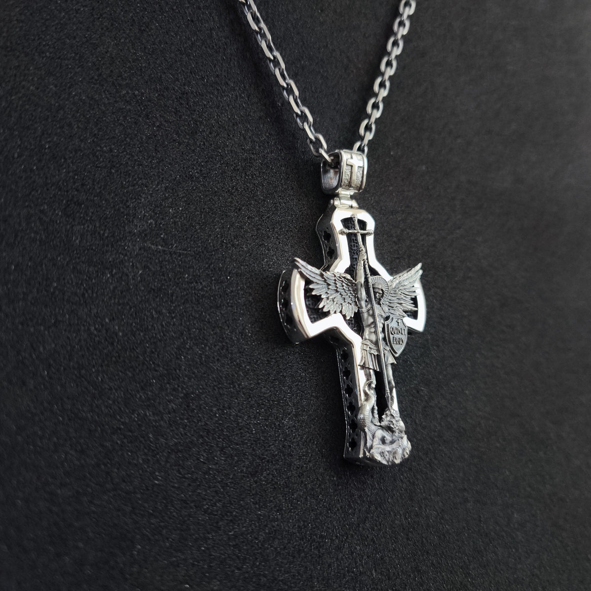 A sterling silver pendant in the shape of Archangel Michael's shield—a religious necklace made of ebony.